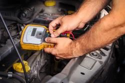 Mechanic running diagnostic on car engine